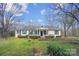 Inviting single-story house with black shutters, a walkway, and green lawn at 7921 Fairmont Dr, Waxhaw, NC 28173