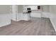 Open kitchen with white cabinets, modern appliances, and a breakfast bar at 7921 Fairmont Dr, Waxhaw, NC 28173