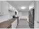 Well-lit kitchen featuring white cabinets and stainless steel appliances at 7921 Fairmont Dr, Waxhaw, NC 28173