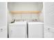 This laundry room features white washer and dryer with a shelf above, enclosed by louvered doors at 7921 Fairmont Dr, Waxhaw, NC 28173