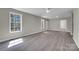 Open-concept living area with neutral paint, ceiling fan, and durable flooring at 7921 Fairmont Dr, Waxhaw, NC 28173