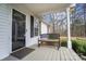 Cozy front porch features a bench, glass front door, and black shutters at 7921 Fairmont Dr, Waxhaw, NC 28173
