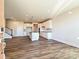 Open concept kitchen with island, hardwood floors, and white cabinets at 95 Seven Oaks Lndg, Belmont, NC 28012