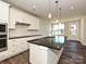 Modern kitchen with white cabinets, granite countertop, and stainless steel appliances at 95 Seven Oaks Lndg, Belmont, NC 28012