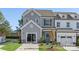 Two-story townhome with gray siding, two-car garage, and landscaped front yard at 11311 Magpie Ct # 2, Charlotte, NC 28215