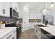 Modern kitchen with white cabinets, farmhouse sink, stainless steel appliances, and gray backsplash at 11311 Magpie Ct # 2, Charlotte, NC 28215