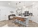Modern kitchen with white cabinets, island with seating, stainless steel appliances, and gray backsplash at 11311 Magpie Ct # 2, Charlotte, NC 28215