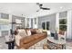 Living room with brown leather sofa, large windows, and access to backyard at 11311 Magpie Ct # 2, Charlotte, NC 28215