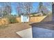 Cozy backyard features a storage shed, mature trees and fenced-in yard at 1211 Pinecrest Ave, Charlotte, NC 28205