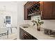 Stylish bar area features a wine rack, sink, and elegant countertops, with view into the dining area at 1211 Pinecrest Ave, Charlotte, NC 28205