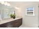 Bathroom boasting a double vanity, white countertops, and a large mirror above with sleek lighting fixtures at 1211 Pinecrest Ave, Charlotte, NC 28205