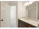 Bright bathroom features a single vanity with storage, a mirror, and an open doorway at 1211 Pinecrest Ave, Charlotte, NC 28205