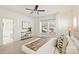 Well-lit bedroom features an open doorway to the bathroom, a ceiling fan, and neutral decor at 1211 Pinecrest Ave, Charlotte, NC 28205