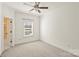 Empty bedroom with an en-suite bathroom featuring neutral walls, carpet, and a ceiling fan at 1211 Pinecrest Ave, Charlotte, NC 28205