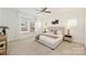 Bright bedroom featuring a large window, neutral tones, and a comfortable-looking upholstered bed frame at 1211 Pinecrest Ave, Charlotte, NC 28205