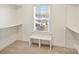 Walk-in closet with neutral walls, a bench, and a window providing natural light at 1211 Pinecrest Ave, Charlotte, NC 28205