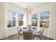 Dining area with large windows, a round table, and seating for four at 1211 Pinecrest Ave, Charlotte, NC 28205