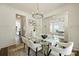 Bright dining room with a glass table and views into the living room and kitchen at 1211 Pinecrest Ave, Charlotte, NC 28205