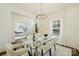 Bright dining room with a glass table, stylish chairs, and modern chandelier at 1211 Pinecrest Ave, Charlotte, NC 28205