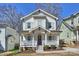 Charming two-story home with a welcoming front porch and well-maintained landscaping at 1211 Pinecrest Ave, Charlotte, NC 28205