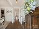 Elegant hallway with hardwood floors, white wainscoting, and a view into the dining room at 1211 Pinecrest Ave, Charlotte, NC 28205