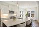 Kitchen island with stainless sink, seating, and modern lighting with pendant lights at 1211 Pinecrest Ave, Charlotte, NC 28205