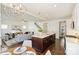 Open concept kitchen and living room with stainless steel appliances and a large center island at 1211 Pinecrest Ave, Charlotte, NC 28205
