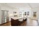 Bright kitchen features stainless appliances, a large island with seating, and a view of the dining area at 1211 Pinecrest Ave, Charlotte, NC 28205
