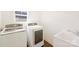 Bright laundry room features modern white machines and a wash basin at 1211 Pinecrest Ave, Charlotte, NC 28205