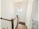 Stairway with wood railing and white walls, natural light from window at 1211 Pinecrest Ave, Charlotte, NC 28205