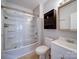 A full bath with a shower-tub combo, white fixtures, wood look flooring, and a medicine cabinet at 1213 Cloninger Ave, Gastonia, NC 28052