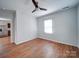 A bright bedroom with hardwood floors, ceiling fan, window, and a hallway view at 1213 Cloninger Ave, Gastonia, NC 28052
