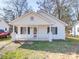 Charming white home with a covered front porch and black shutters at 1213 Cloninger Ave, Gastonia, NC 28052