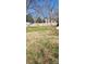 Large back yard featuring mature trees, a storage shed, and a privacy fence at 128 N Oak St, Salisbury, NC 28146