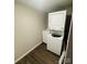 Laundry room featuring a stacked washer and dryer, new flooring, and fresh paint at 128 N Oak St, Salisbury, NC 28146