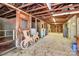 A horse stall exhibiting an open ceiling with exposed rafters and wooden horse and carriage models at 1354 Mirror Lake Rd, Lincolnton, NC 28092