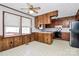 Functional kitchen with wood cabinets, white countertops, and appliances at 1354 Mirror Lake Rd, Lincolnton, NC 28092