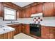 Classic kitchen with wood cabinets, white countertops, and vintage-style backsplash at 1354 Mirror Lake Rd, Lincolnton, NC 28092
