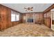 Cozy living room featuring wood paneling, a brick fireplace, and a rocking chair at 1354 Mirror Lake Rd, Lincolnton, NC 28092