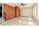 Spacious, sunny room featuring tile floors, a brick wall, and a decorative front door at 1354 Mirror Lake Rd, Lincolnton, NC 28092