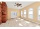 Bright living room with a brick accent wall, tile flooring, and ample natural light at 1354 Mirror Lake Rd, Lincolnton, NC 28092