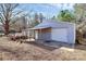 Large outbuilding features roll-up door and covered porch at 1354 Mirror Lake Rd, Lincolnton, NC 28092
