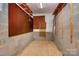 Functional storage area with pegboard walls, basic shelving, and durable concrete block construction at 1354 Mirror Lake Rd, Lincolnton, NC 28092