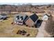Aerial view of this lovely home showcasing its brick facade, landscaping, detached garage, and long driveway at 144 Cameron Dr, Salisbury, NC 28147