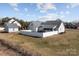Aerial view of the backyard, fence, detached garage, and the rear of the home at 144 Cameron Dr, Salisbury, NC 28147