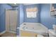 Bright bathroom features a soaking tub with a glass block window at 144 Cameron Dr, Salisbury, NC 28147