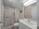 Bright bathroom featuring a shower with glass door, and white sink and vanity at 144 Cameron Dr, Salisbury, NC 28147
