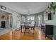 Bright dining area with hardwood floors, multiple windows, and view of the landscaped backyard at 144 Cameron Dr, Salisbury, NC 28147