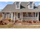 Close up of the covered front porch on this red brick home with dormer windows at 144 Cameron Dr, Salisbury, NC 28147