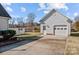 Close up of the detached garage on the property featuring an entry door and garage door at 144 Cameron Dr, Salisbury, NC 28147